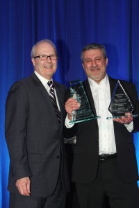 Mike Sloan (right), Horizons Window Fashions National Sales Manager, accepts Supplier of the Year and Sales Achievement Awards from Decorating Den Interiors Vice President for Merchandising and Marketing David Haseley.
