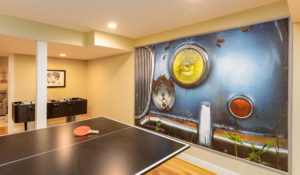 basement game room with artwork